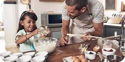 Dad and daughter making cookies