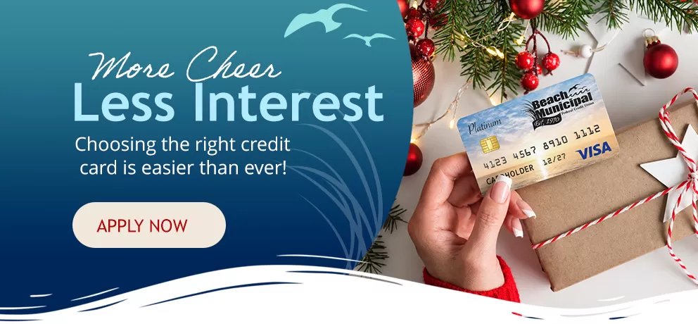 Woman\'s hands holding a Beach Municipal FCU credit card while wrapping a holiday gift