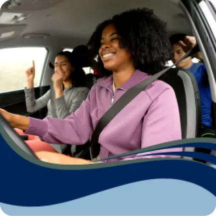 Woman smiling driving a car